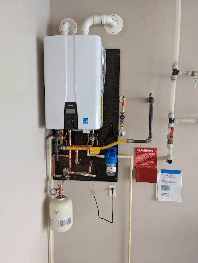 Professional plumber installing copper piping in a Niwot home